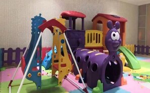 A children's play area with a train set, slides, and climbing structures. - Homeinn Selected Hotel (Beijing Beixinqiao Nanluoguxiang) (Beijing)