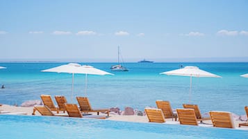On the beach, sun-loungers, beach umbrellas, beach towels