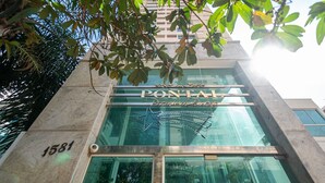El exterior del hotel Pontah, con fachada de vidrio, un adorno con estrella y el número 1581 en el edificio.