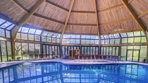 A large indoor swimming pool with a high ceiling and large windows. - Pocono Mountains Camelback Retreat-Stunning Views (Tannersville)