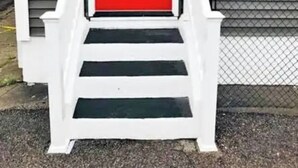 A red door with a white porch and steps leading up to it. - The Micro-Loft at Mt. Pleasant New 2BR APT Parking (Providence)