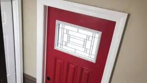 A red door with a white frame and a small window. - The Micro-Loft at Mt. Pleasant New 2BR APT Parking (Providence)