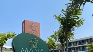 A sign for "MANA Beach Experience" with a modern building in the background. - Mana Beach Experience 217Aloha byLaPlaya (Ipojuca)