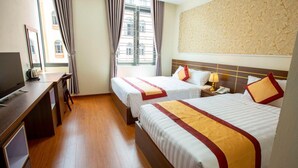 A hotel room with two beds, a desk, and a TV. -  Ruby Ha Long 6 Hotel (Bai Chay)