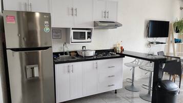 Fridge, microwave, cookware/dishes/utensils, spices