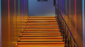 A staircase with a 'WELCOME' sign at the top.