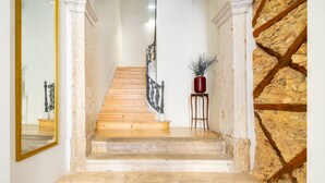 A staircase with wooden steps and a metal railing, leading to an upper floor. - Alcântara Premium Apartment (Lisbon)