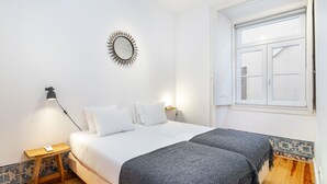 A bedroom with a bed, bedside table, lamp, and a mirror on the wall. - Alecrim 43 Top Location Perfect To Explore Lisbon (Lisbon)
