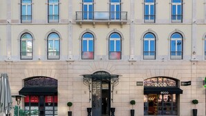 A multi-story building with a central entrance, balconies, and a storefront with a sign. - The Boulevard Prime Location W/ Elevator (Lisbon)