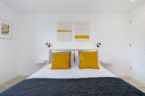 A neatly arranged bedroom with a bed, two bedside tables, and a headboard. - Wilderness Escape: Secluded Haven For Remote Work (Sintra)