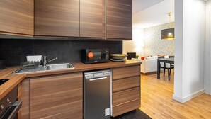 A modern kitchen with wooden cabinets, a dishwasher, and a microwave.