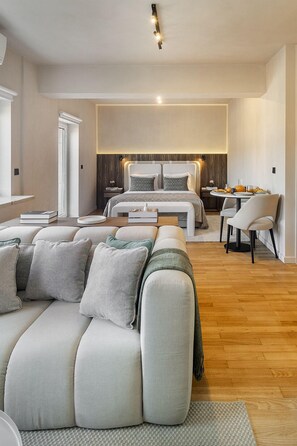 Relax in this serene bedroom with a large bed, bedside table, and comfortable chair.