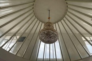 A circular ceiling with a hanging chandelier and skylights. - Srinivasa Hotel (Chittoor District)
