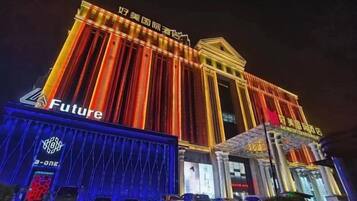 A building with illuminated vertical stripes and a sign that reads 'Future.'