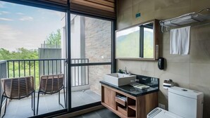 A modern bathroom with a large window, a sink, a mirror, and a toilet. - The Silence Manor (Hualien)