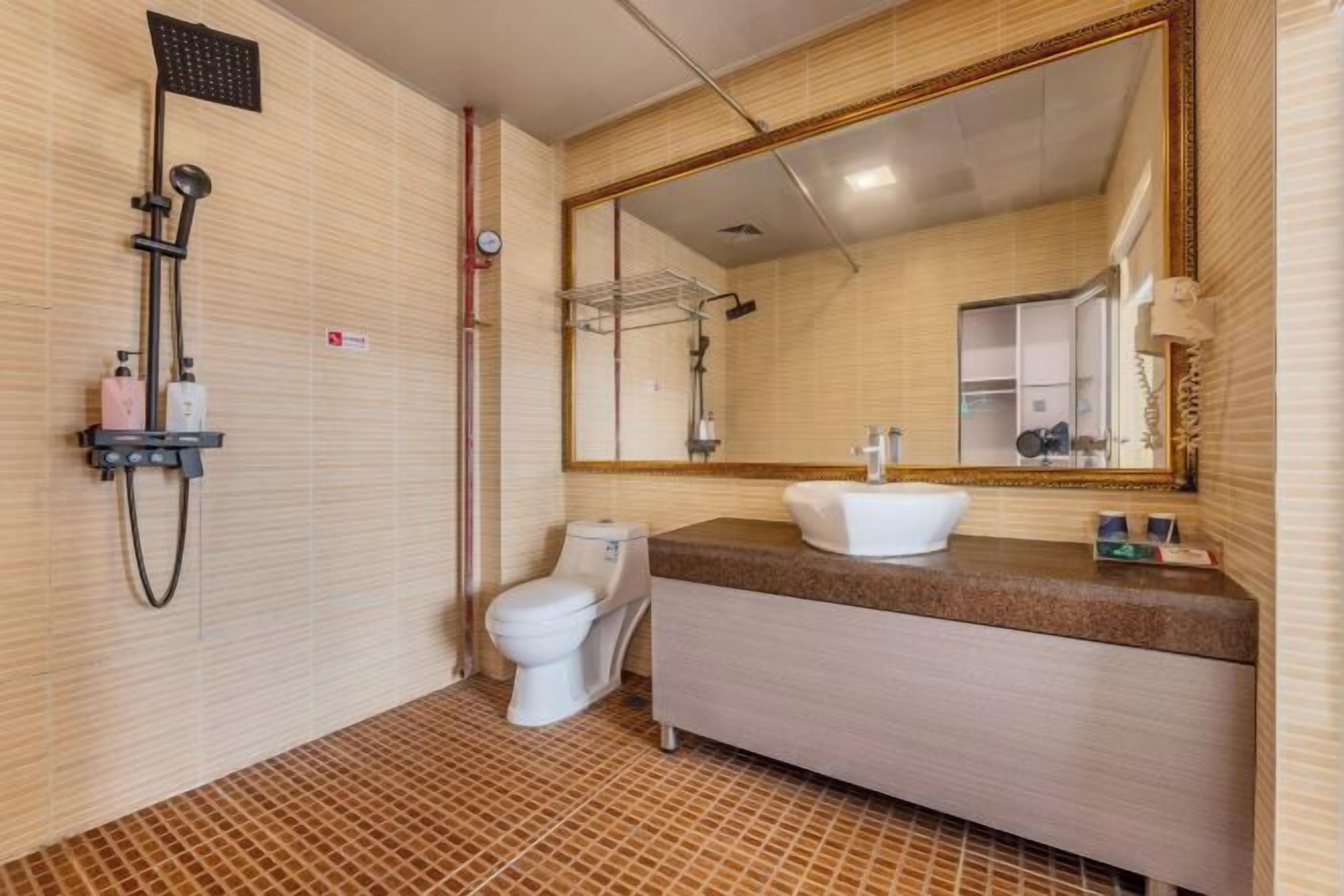 A bathroom with a shower, toilet, and sink.