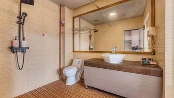 A bathroom with a shower, toilet, and sink.