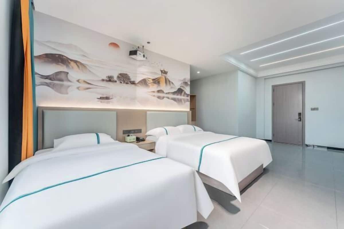 A hotel room with two beds, a large wall mural, and a modern ceiling design.