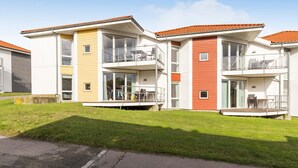 A modern multi-story residential building with balconies, large windows, and a flat roof. - Gudhjem Søpark Lejl. 18 (Gudhjem)