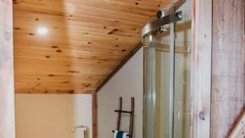 A compact bathroom with a shower, toilet, and bathtub.