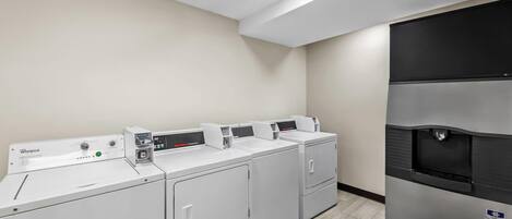 A laundry facility with four Whirlpool washers and a Burkett dryer.