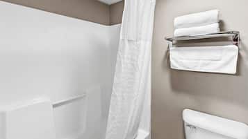 A bathroom with a shower, a toilet, and a towel rack with towels.