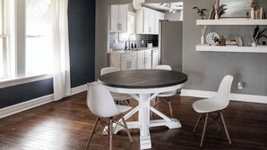 A modern kitchen with white cabinets, a central island, and pendant lighting. - 7 min to Downtown / W/D / Historic / Central (Oklahoma City)