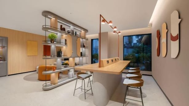 A modern kitchen with a central island, bar stools, and a large window offering a view of the outdoors. - Home Inn (Shanghai Stadium Wanping South Road) (Shanghai)