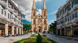 A cathedral with twin spires, surrounded by historic buildings with balconies. - ZhuXing Hotel (Guangzhou)