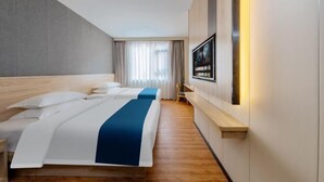 A hotel room with two beds, a TV mounted on the wall, and a large window with curtains. - ZhuXing Hotel (Guangzhou)