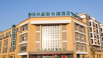 A hotel with a prominent sign, multiple floors, and a clear entrance.
