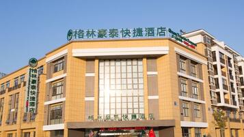 A hotel with a modern facade, multiple floors, and a prominent signage.