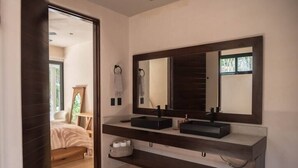 A modern bathroom with two sinks, a large mirror, and a wooden floor. - Luxury House in the Jungle with Pool by BT Homes (Tulum)