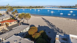 A coastal area with a beach, boats, and buildings. - Beach Dream - Steps to the boardwalk & beach with AC, WiFi, deck, prime location! (San Diego)