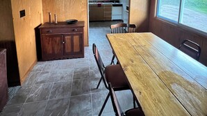 Cocina compacta con comedor, muebles de madera y un amplio ventanal con vistas.
