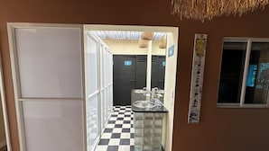 A hotel bathroom with a checkered floor, a sink, and a mirror. - Lucca Hostel (Medellín)