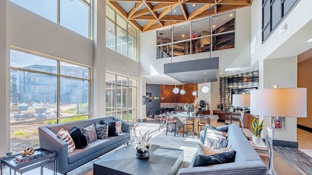 A spacious living area with a large sofa, coffee table, and dining area. - Best stay in Austin (Austin)