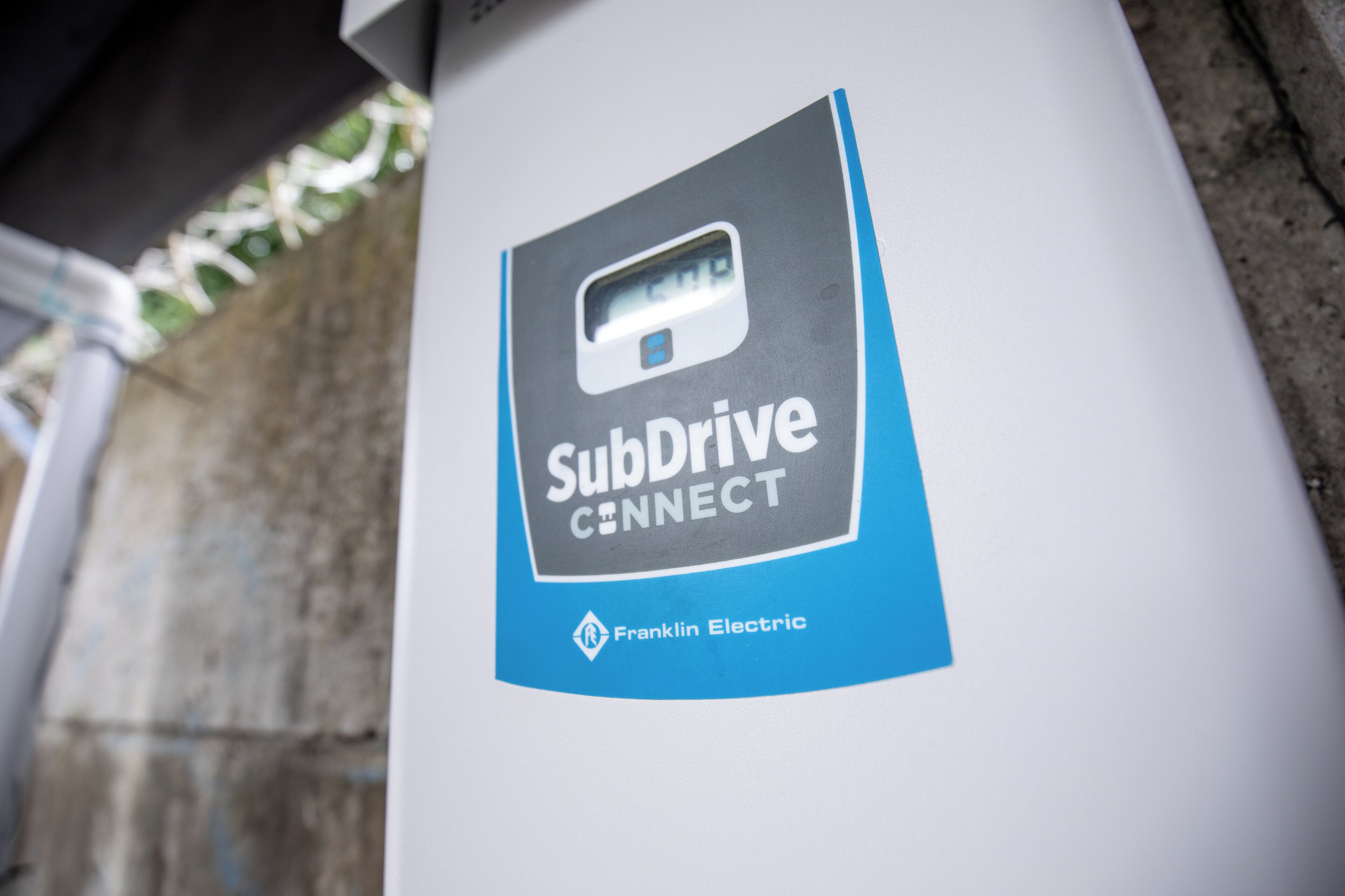 A close-up of a SubDrive CONNECT sign on a pillar.