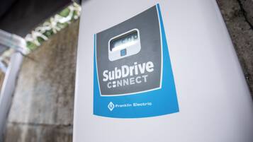 A close-up of a SubDrive CONNECT sign on a pillar.
