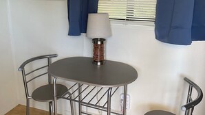 A small room with a round table, two chairs, a lamp, and a framed picture on the wall. - Secret Garden in gorgeous Sedona with AC, WiFi (Sedona)