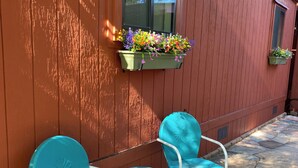 A wooden building with a window and flower boxes. There are two blue chairs outside. - Secret Garden in gorgeous Sedona with AC, WiFi (Sedona)