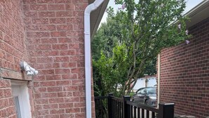 A brick building with a concrete staircase and a black metal railing. - Grapeview Lower Level Apartment (St. Catharines)