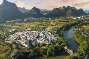 An aerial view of a town with a river, surrounded by mountains. - Serene Vale Inn Guilin (Guilin)