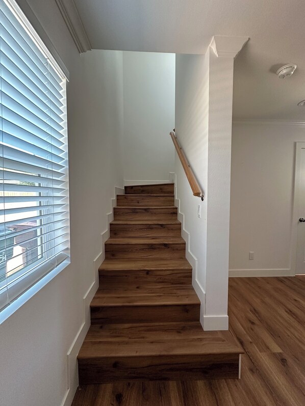 A staircase with wooden steps and white walls.