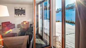 A room with a view of a snowy landscape through a glass door. - Cosy apartment in villa for 5 guests with WIFI, TV, terrace and pets allowed (Kobylnice)