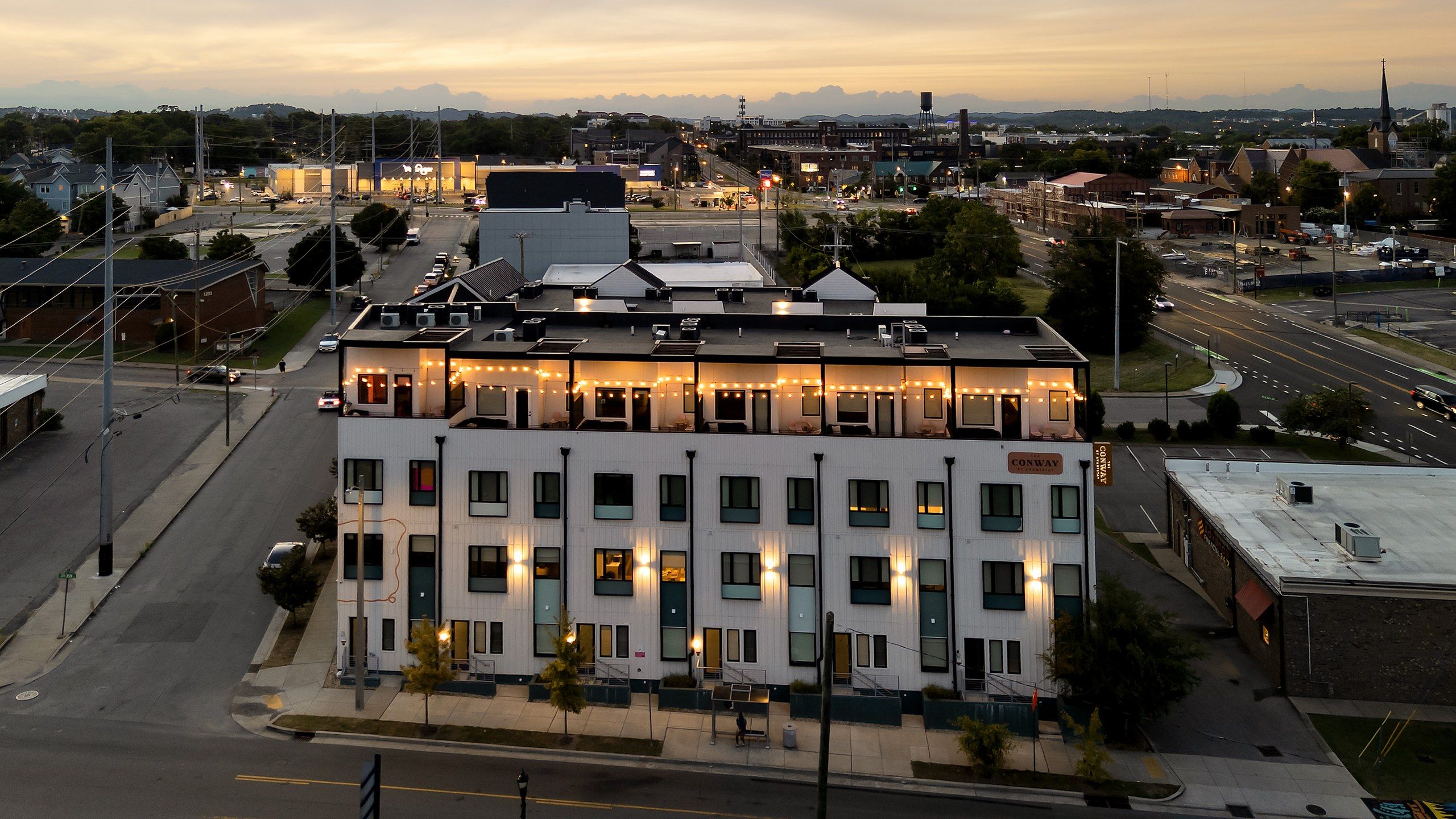 A multi-story hotel with a flat roof, large windows, and a sign indicating it is the Conway Hotel.