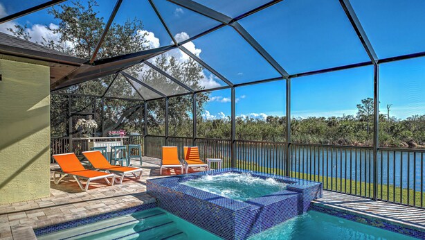 A pool area with a hot tub, lounge chairs, and a view of the surrounding landscape. - Amazing Octopus | Pool | Spa | outdoor Bar | Office (Placida)