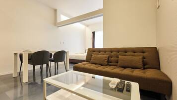 Comfort Quadruple Room | Living area | Flat-screen TV