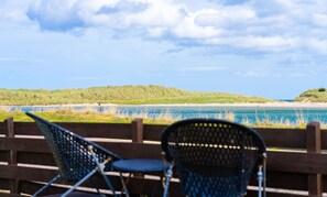 A view of a beach with two folding chairs and a wooden fence. - Beach Cottage Pet Child Friendly Stay in Moray (Lossiemouth)
