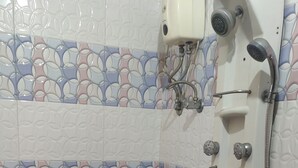 A bathroom with a toilet, bidet, and sink. - Trio hotel (Vasai)